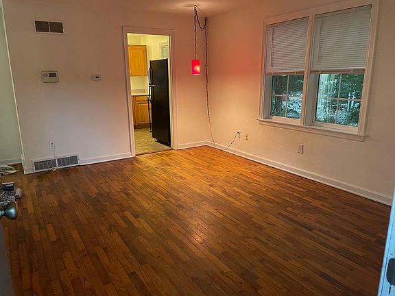 Living room pictured from front door. Programmable thermostat.