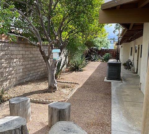 Spacious side yard with lemon tree.