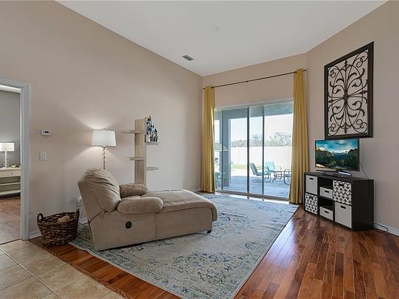 Living Room with Sliders to the covered patio- Backyard has roo for a pool