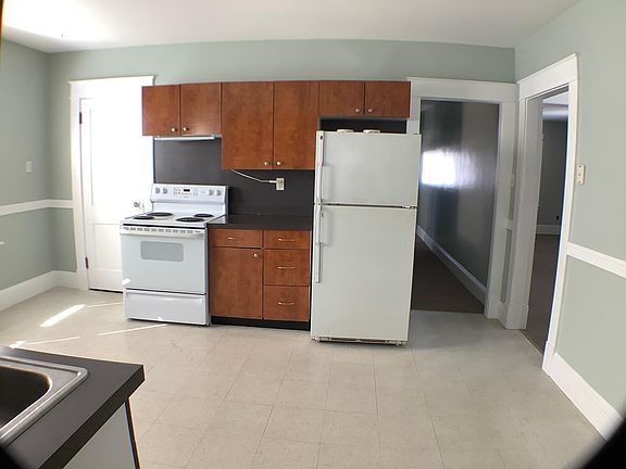 Kitchen with stove, refrigerator and dishwasher.