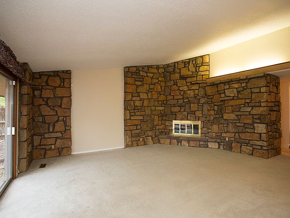 Corner wood burning fireplace with gas starter.