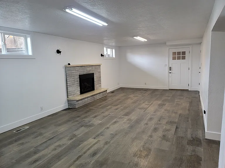 Front room with fireplace and entry