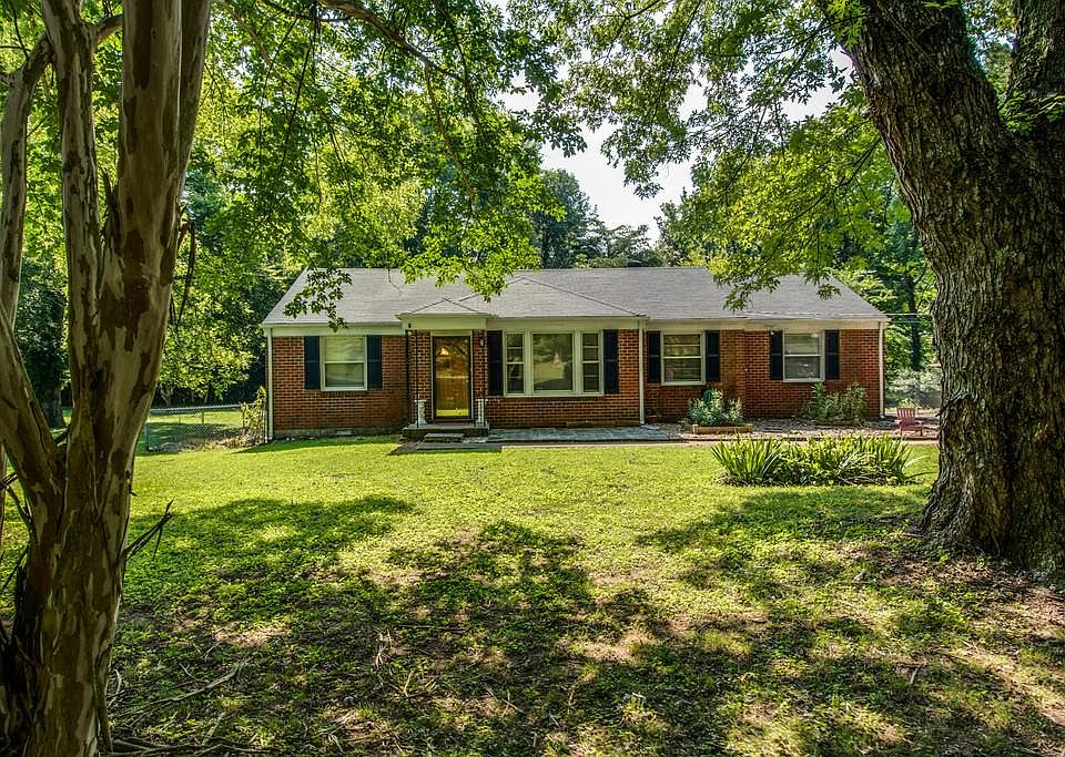 Huge flat front yard with plenty of trees.