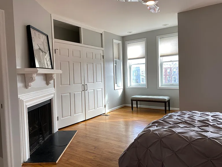 Master bedroom, large, fireplace, sunny, ample clothing storage.