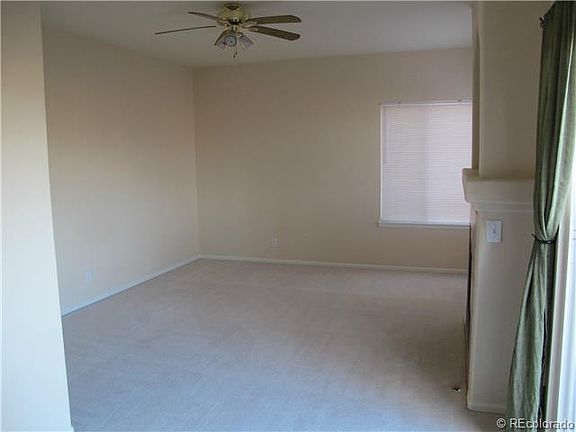 Cozy family room with gas fireplace and ceiling fan