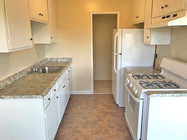 New countertops, appliances. Gas stove. Kitchen looking toward entry hallway