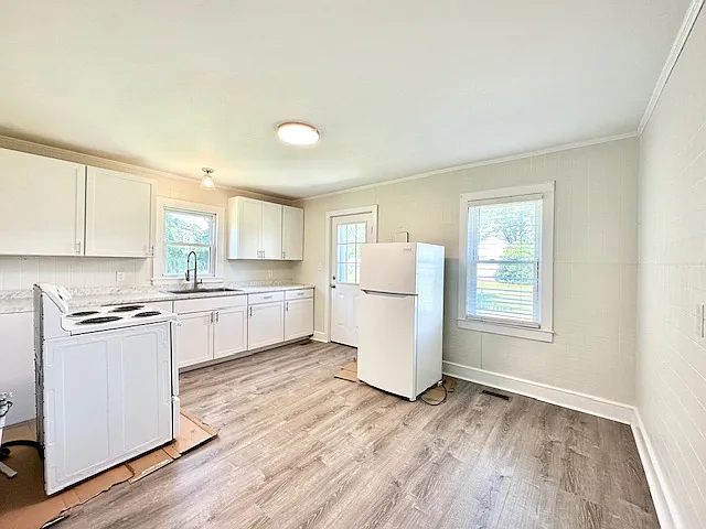 Kitchen with appliances. Washer and Dryer has been added. Appliances were on cardboard as the flooring was just completed. They have been positioned appropriately.