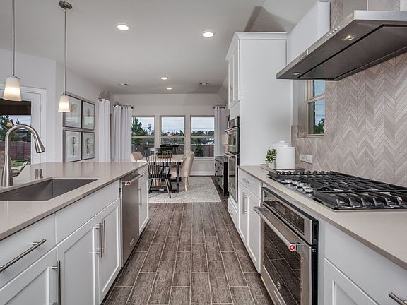Stunning island kitchen with tons of cabinet and counter space model representation