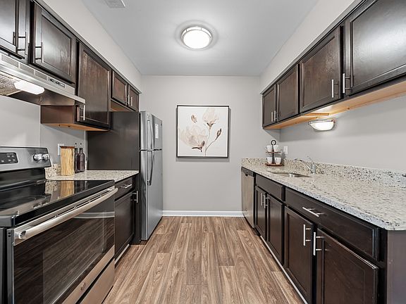 Spacious Kitchen with stainless steel appliances and dark cabinets at Lakeside Village Apartments Clinton Township, MI