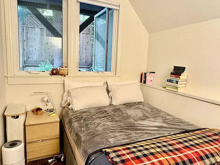 Bedroom with large windows fits queen size bed.