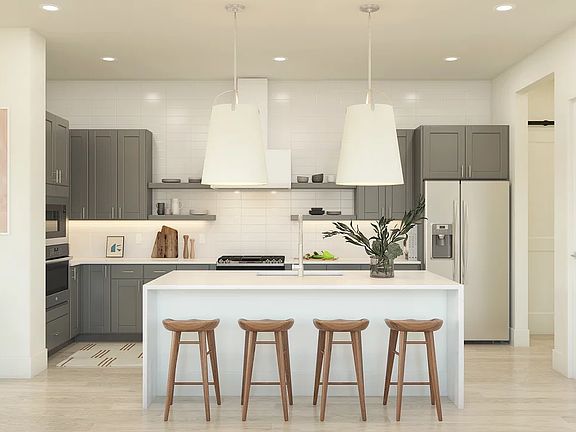 Kitchen with waterfall island and pendant lighting