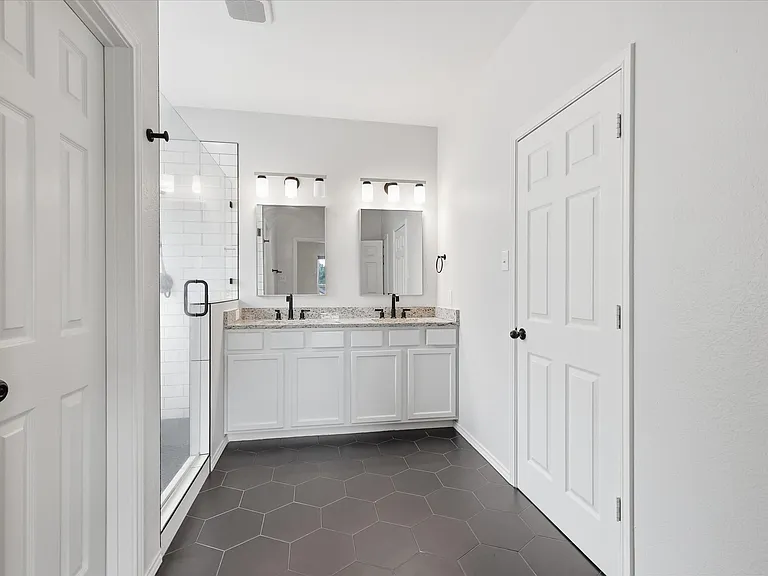 Primary bathroom - double sinks, watercloset and walk-in closet