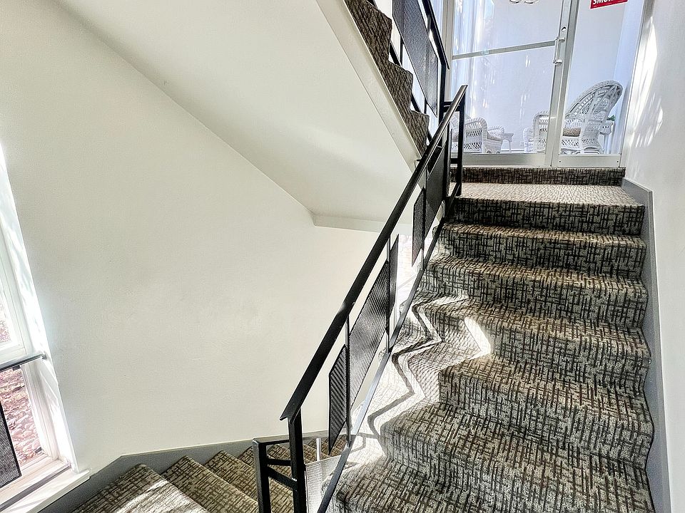 Step into elegance with this well-lit stairway, offering style and comfort.