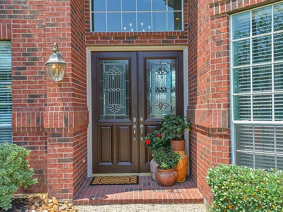 The attention to detail is apparent before you even enter the property. With features like the leaded glass door and the brick front porch, this home is stunning.