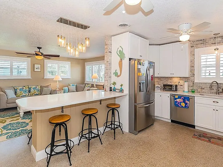 kitchen view from garage door. Island with 6 stools, not shown is kitchen table with 2 stools.