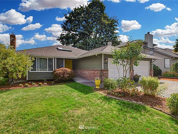 Level manicured lawn with easy care plantings.