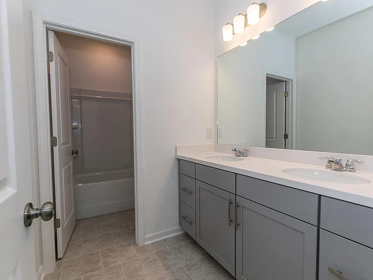 Secondary suite bathroom with a tub and shower combination
