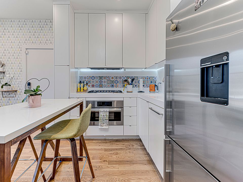 Modern appliances including a gas stove, microwave, and dishwasher.