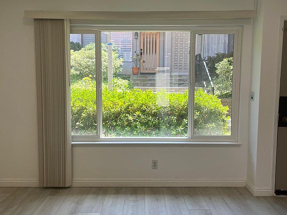 Spacious living room with new flooring , paint and recessed lights