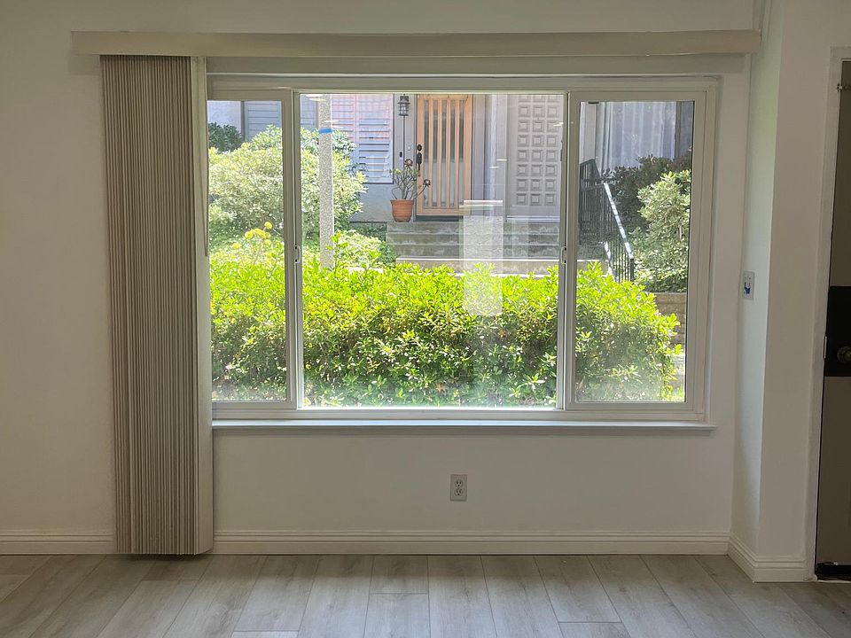 Spacious living room with new flooring , paint and recessed lights