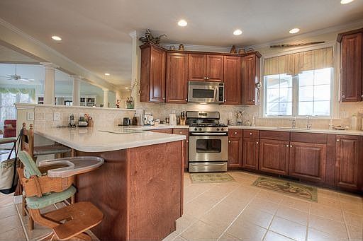 Kitchen with cherry backlit cabinets