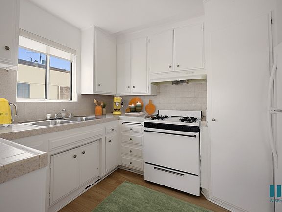Kitchen with Stove, Refrigerator, and Ample Cabinet Storage