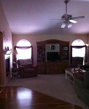 Large Great Room with see-thru fireplace and arched windows over