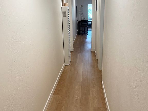 Long hallway with floors less than a year new