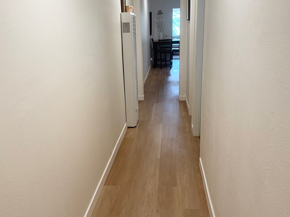 Long hallway with floors less than a year new