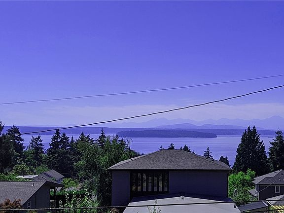 Welcome to 7238 39th Ave SW, a historic home with beautiful views of Puget Sound (this photo taken from an upstairs window). 