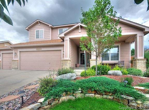 Front of home with exceptional landscaping