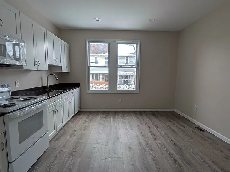 fully updated kitchen with granite countertops and all new appliances (refrigerator, stove/oven, dishwasher, microwave) and large breakfast area