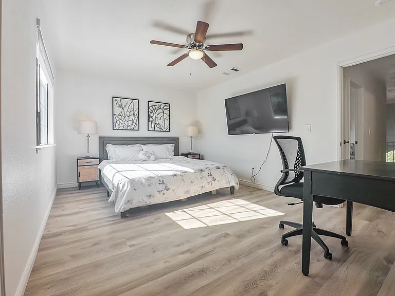 Bedroom # 1 with a king bed, work station, smart TV, and en suite full bathroom