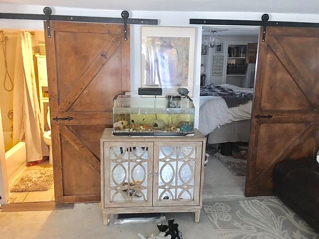 sliding barn doors at the bathroom and bedroom number one