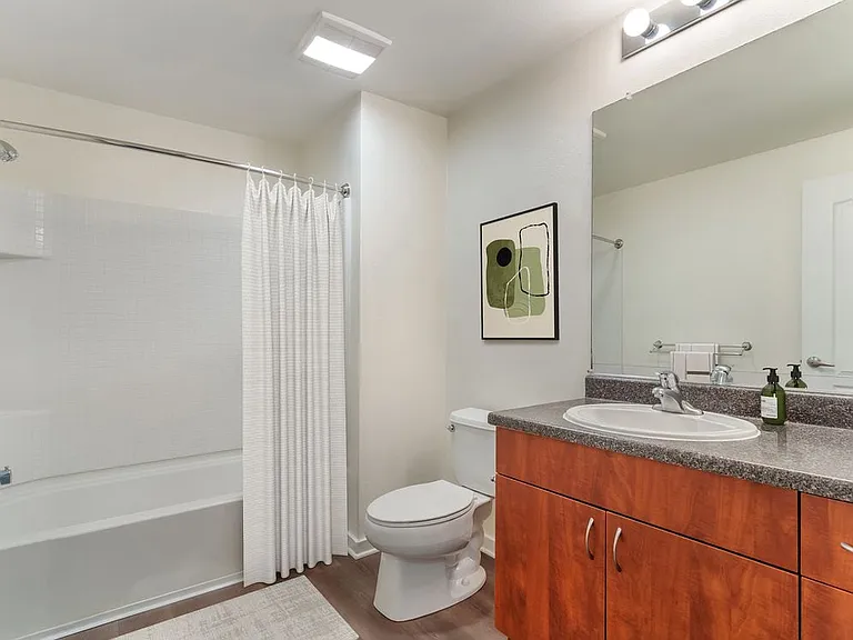 Classic Package II bath with grey laminate countertop, cherry cabinetry, and hard surface flooring