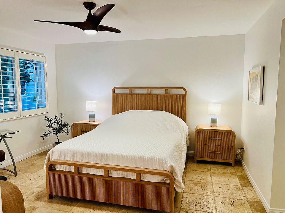 Primary, spacious, queen-sized bedroom with matching bedside tables, bureau and small desk for cosmetics or laptop