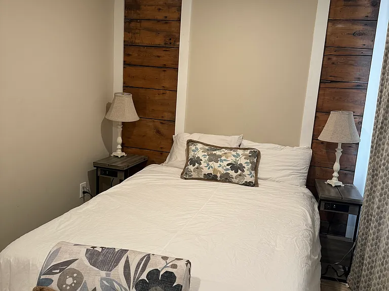 Bedroom #1 with full size mattress, small cupboard, two windows with blackout shades and individually zoned A/C and heat.