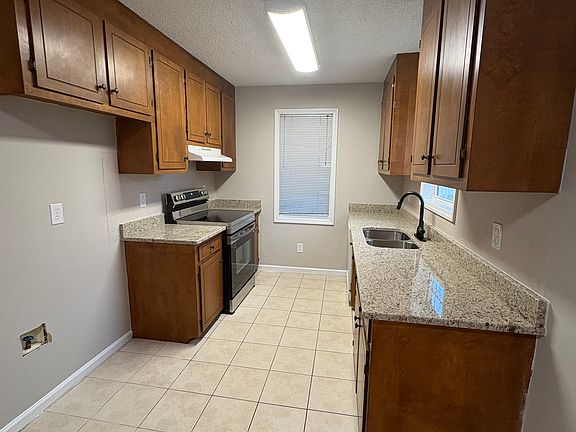 Kitchen: New countertops, sink, faucet, and stove