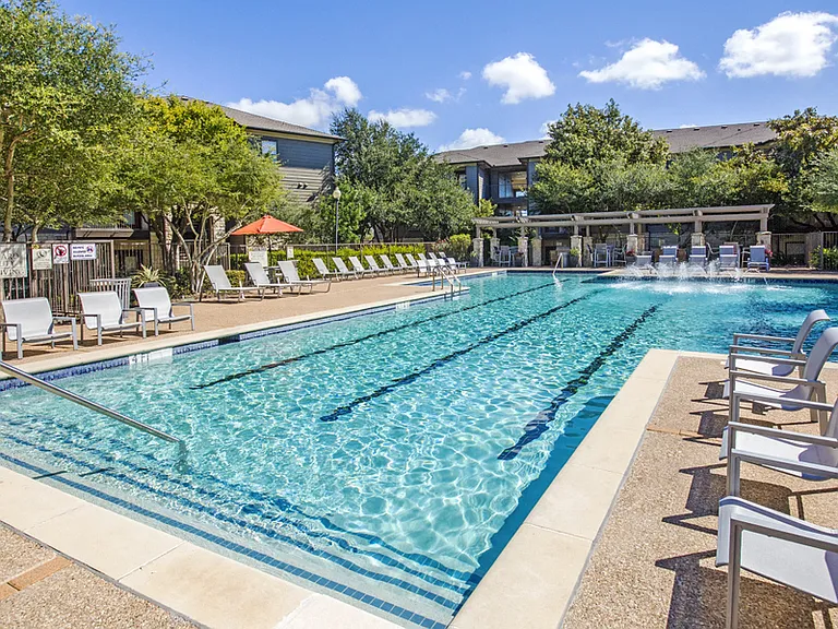 Austin Apartments - Expansive Swimming Pool Surrounded By Various Lounge Chairs