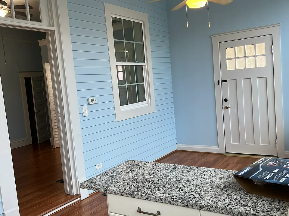 Kitchen island features drawer storage and barstool seating for three chairs