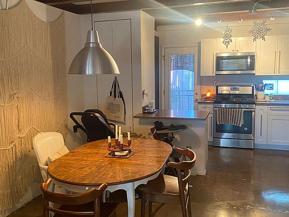 dining with kitchen and breakfast bar behind