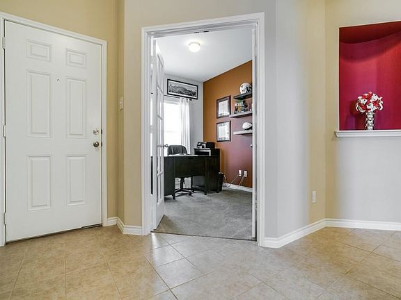 Beautiful entry, view into study with glass french doors