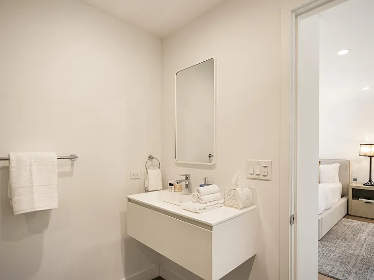 Refresh in the elegant ensuite bathroom, featuring modern amenities and sophisticated decor.
