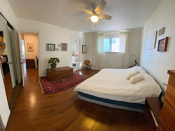 Bedroom with 2 huge semi-walk-in closets. Entrance to square bathroom seen in the center of the photo.