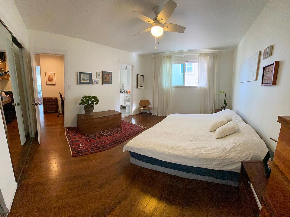Bedroom with 2 huge semi-walk-in closets. Entrance to square bathroom seen in the center of the photo.