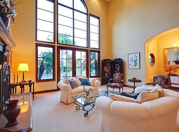 Living room w/ a fireplace, office area & arched low -E windows