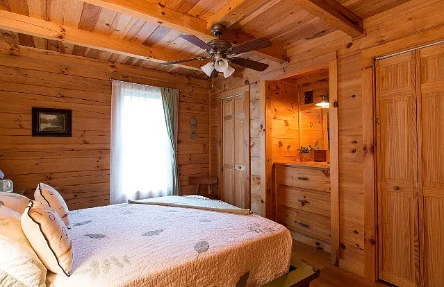 Guest Bedroom with built in drawers, two closets, and adjacent semi-private full bath.