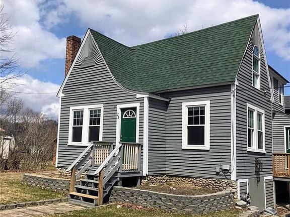 Front of house with 2 available garden beds