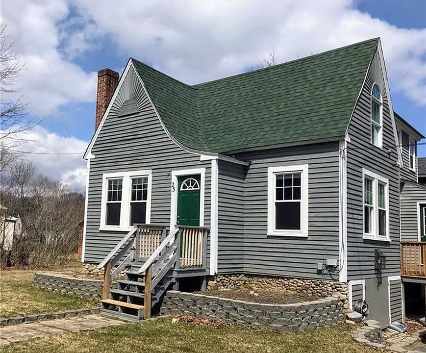 Front of house with 2 available garden beds