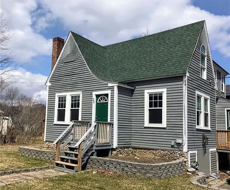 Front of house with 2 available garden beds